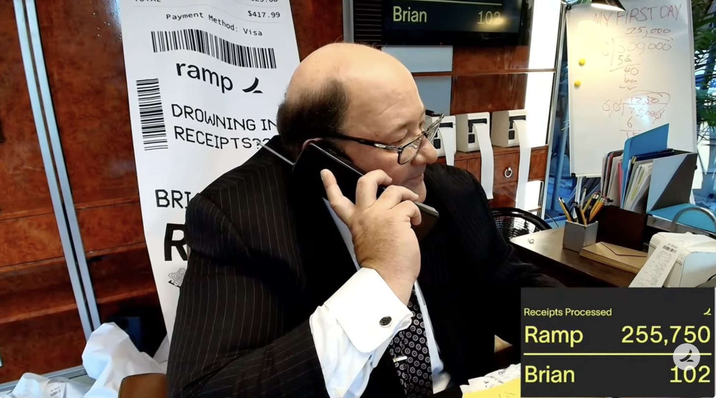 Brian on the phone inside the box with the live scoreboard showing Ramp 255,750 to Brian 102