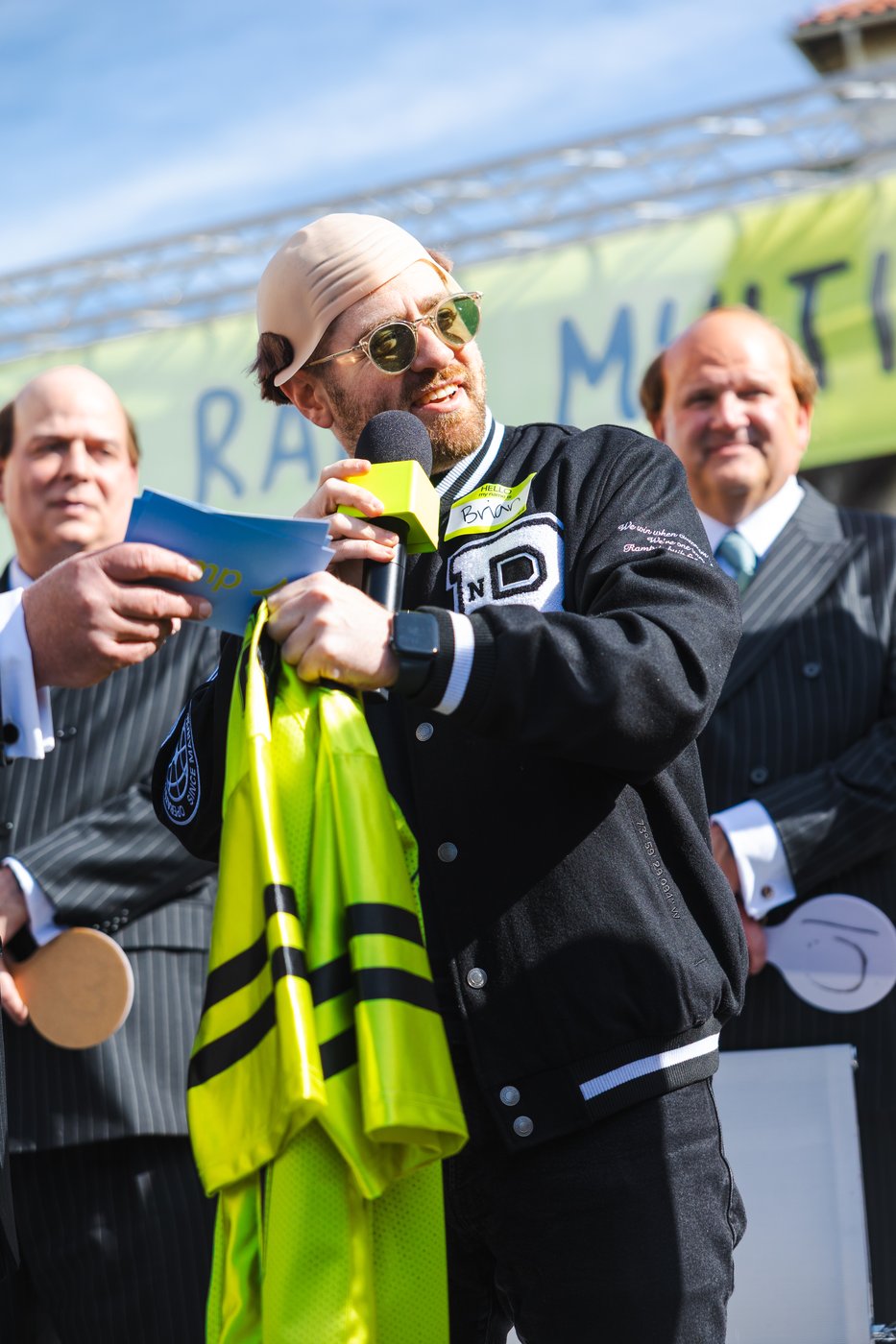A look-alike contest winner receiving a jersey on stage